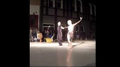 A couples ballroom dance performed on the street.