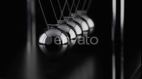 The balls of a Newtons Cradle colliding in slow motion | Stock Footage - Envato elements