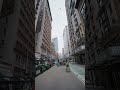 Point of view showing person walking in downtown Manhattan revealing architecture and skyscrapers of