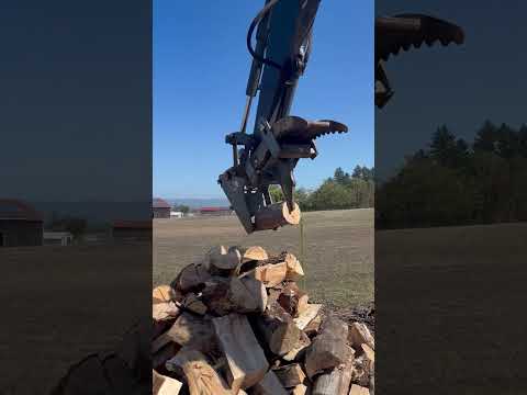 Excavator splitting firewood