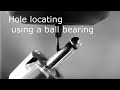 Hole locating using a ball bearing