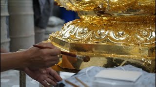 Applying Gold Leaf to Bronze Buddha Statue