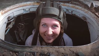 Девушка учится водить танк