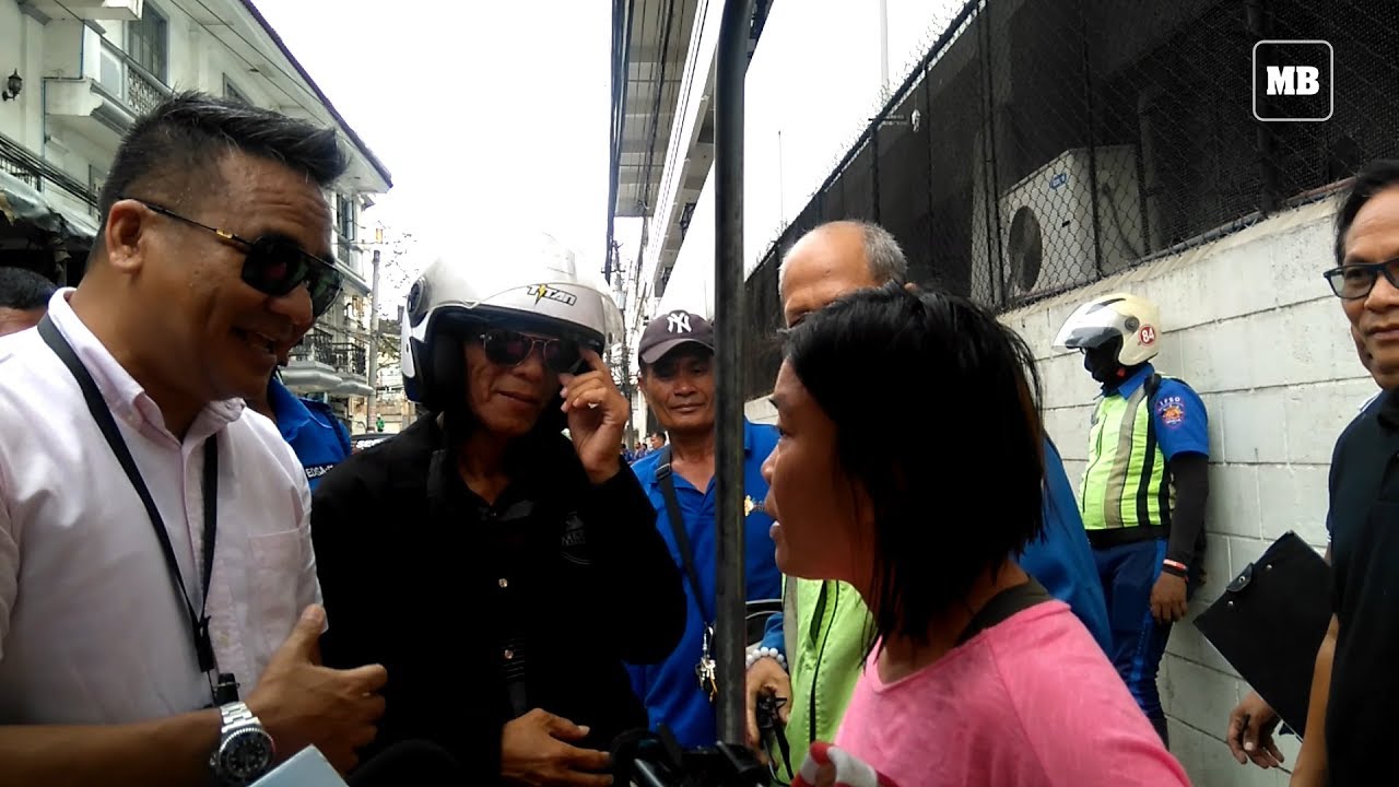 Woman tries to stop MMDA from towing her motorized food stall in Intramuros