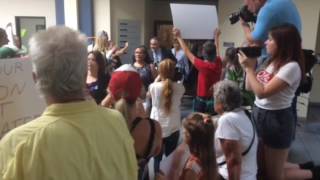 Protesters shout at New Hanover County, Brunswick County and Chemours officials as they leave the Ge