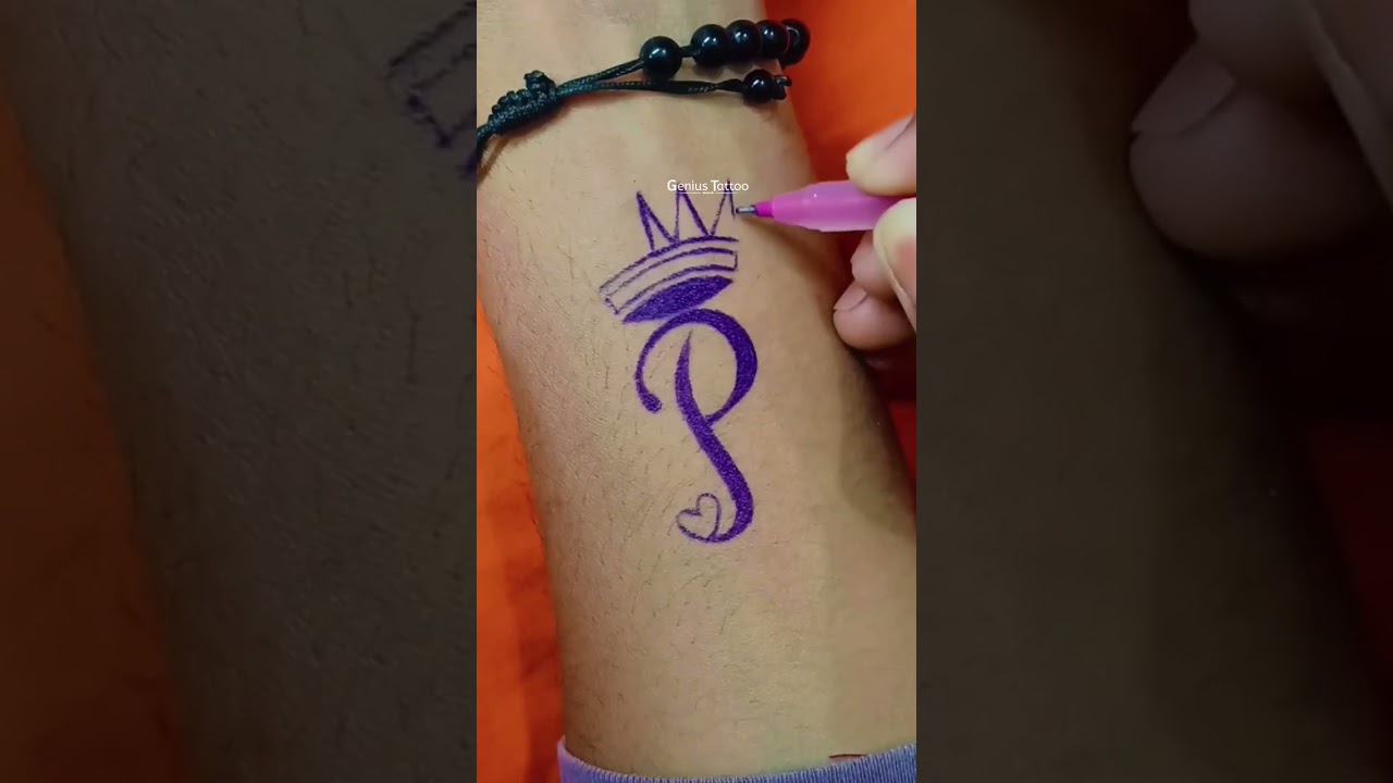 Stylish P letter tattoo making with Pen on hand 