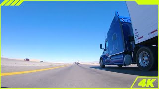 Endless Open Highway Drive with Truck Traffic Nevada Desert Under Clear Blue Sky