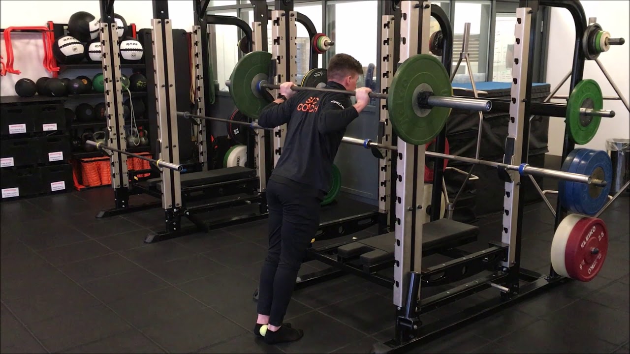 Double Leg Calf Raises In Rack With Tennis Ball - YouTube