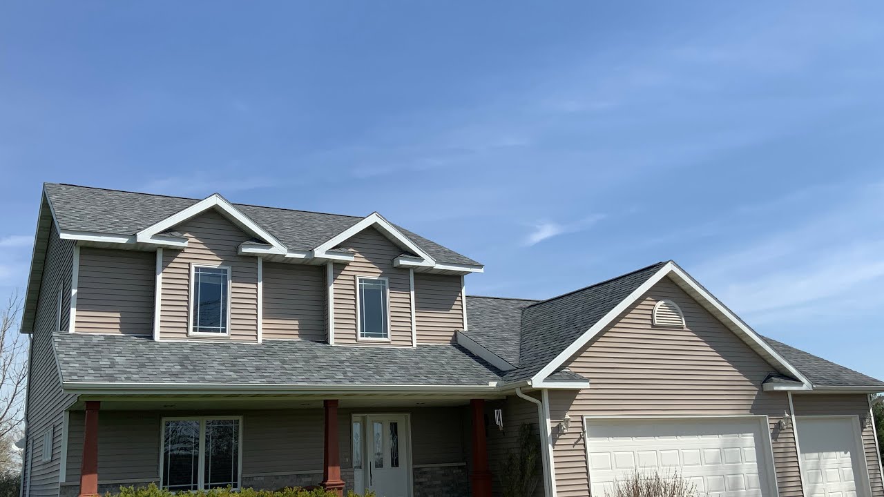 CRAFTSMAN EXTERIORS- HAIL DAMAGED ROOF IS RESTORED IN SLATESTONE GRAY.