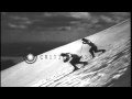 Men sliding downhill and demonstrating the jump turns and terrain turns in the Un...HD Stock Footage