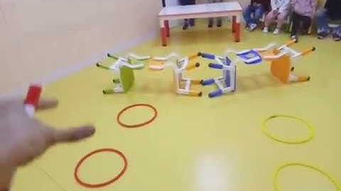 ESL flashcards game using chair, table and hoops. (MA Muxi)