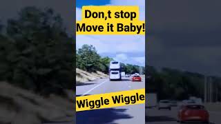 Car transporter wiggles all over the road due to it being badly loaded.