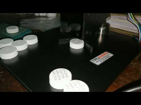 Table top batch coding machine - printing on caps