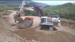 Caterpillar 345B Excavator Loading 12-wheeler Dump Trucks