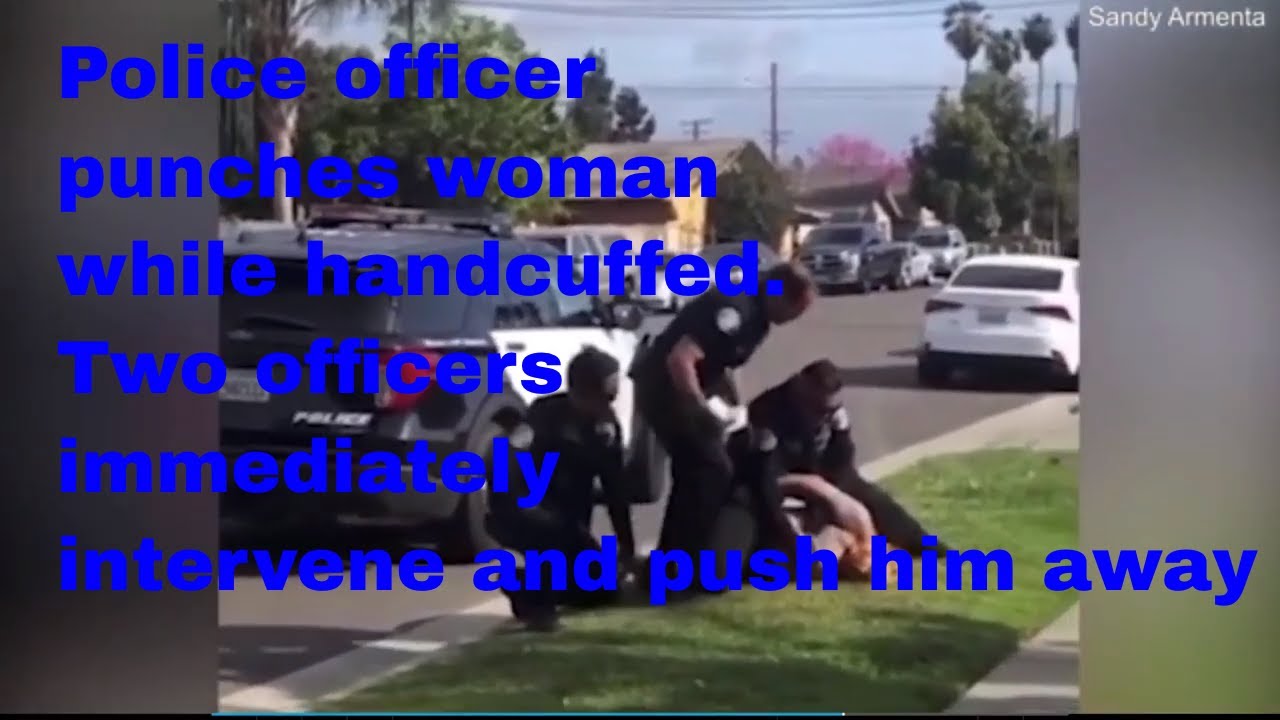 Police officer punches woman while handcuffed. Two officers immediately intervene and push him