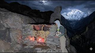Building a survival rock shelter with a bushcraft camping fireplace in the snowy mountains