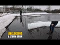 #066-3 Unclogging a storm drain on a parking lot after snowfall in Germany