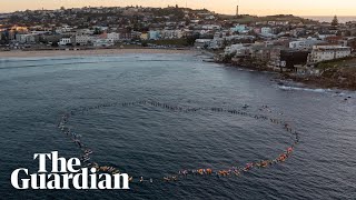 Hundreds honour Westfield stabbing victims with paddle-out at Bondi beach