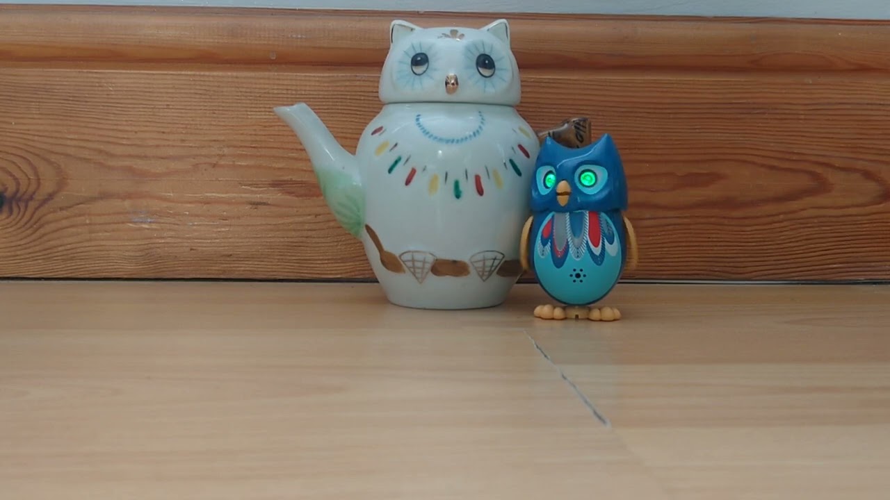 Teapot Tuesday. Week 23: Blue DigiOwl, singing next to an owl teapot.