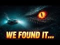 Hunting giant squid with robots glowing sea monster eye in darkness