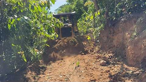 The Process of Widening Forest Roads Using a CAT D6R XL Bulldozer in Tough Terrain Conditions