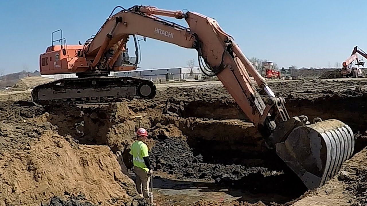 Backhoe Excavator Heavy Equipment digging footings. Time lapse