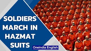 North Korea: Soldiers march in orange hazmat suits| Oneindia News screenshot 5
