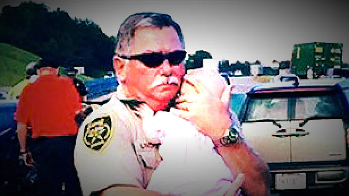 Sheriff's Deputy Ric Lindley calming a baby at the scene of a car crash.