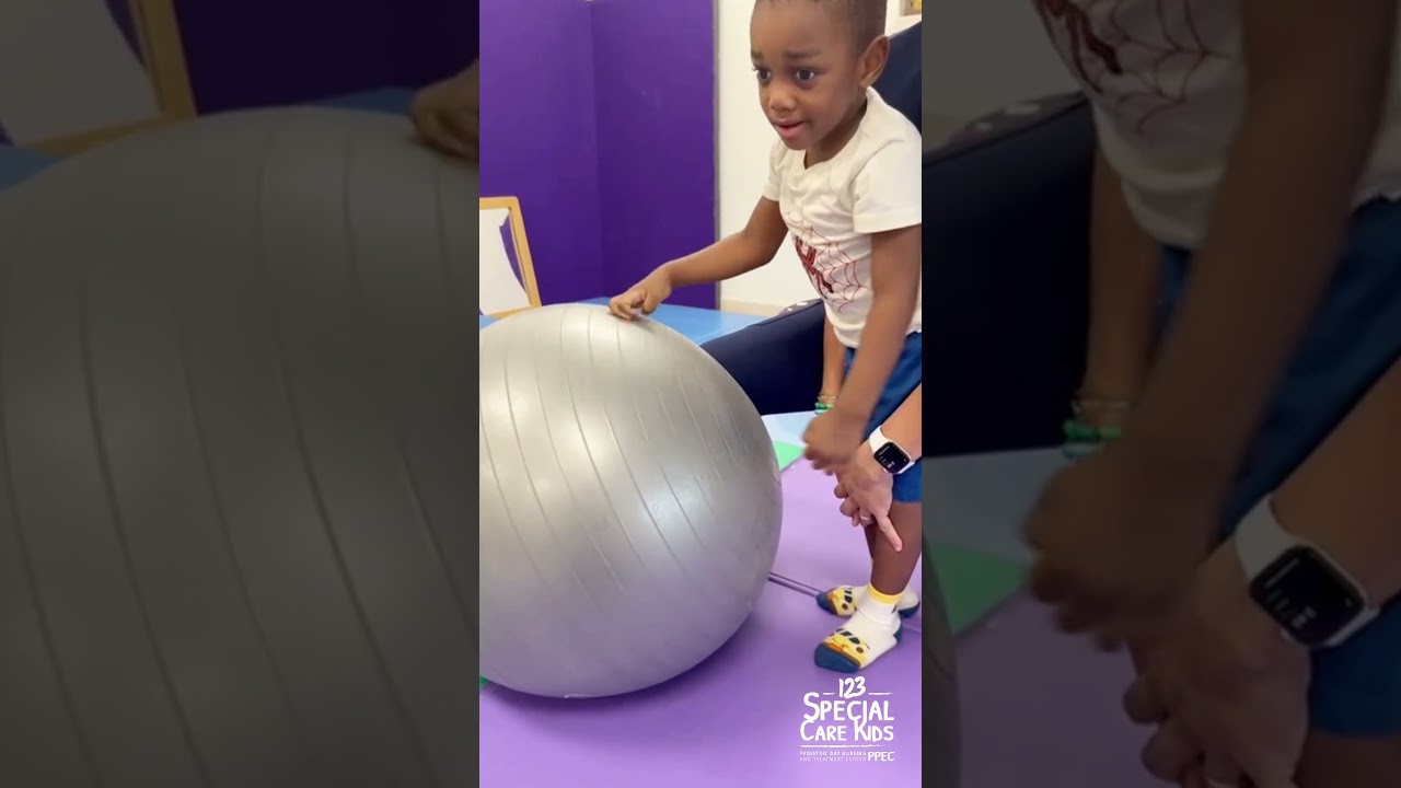 Working on full weight bearing of feet on ground and full extension of knees while playing with ball