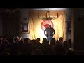 Miles crawford compereing at the covent garden comedy club receiving a standing ovation may 2023