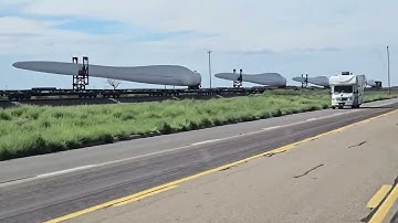 Wind Turbines On Train Through Desert