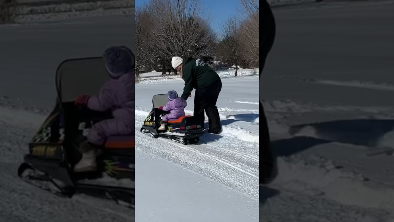 15 month old riding her first snowmobile! 