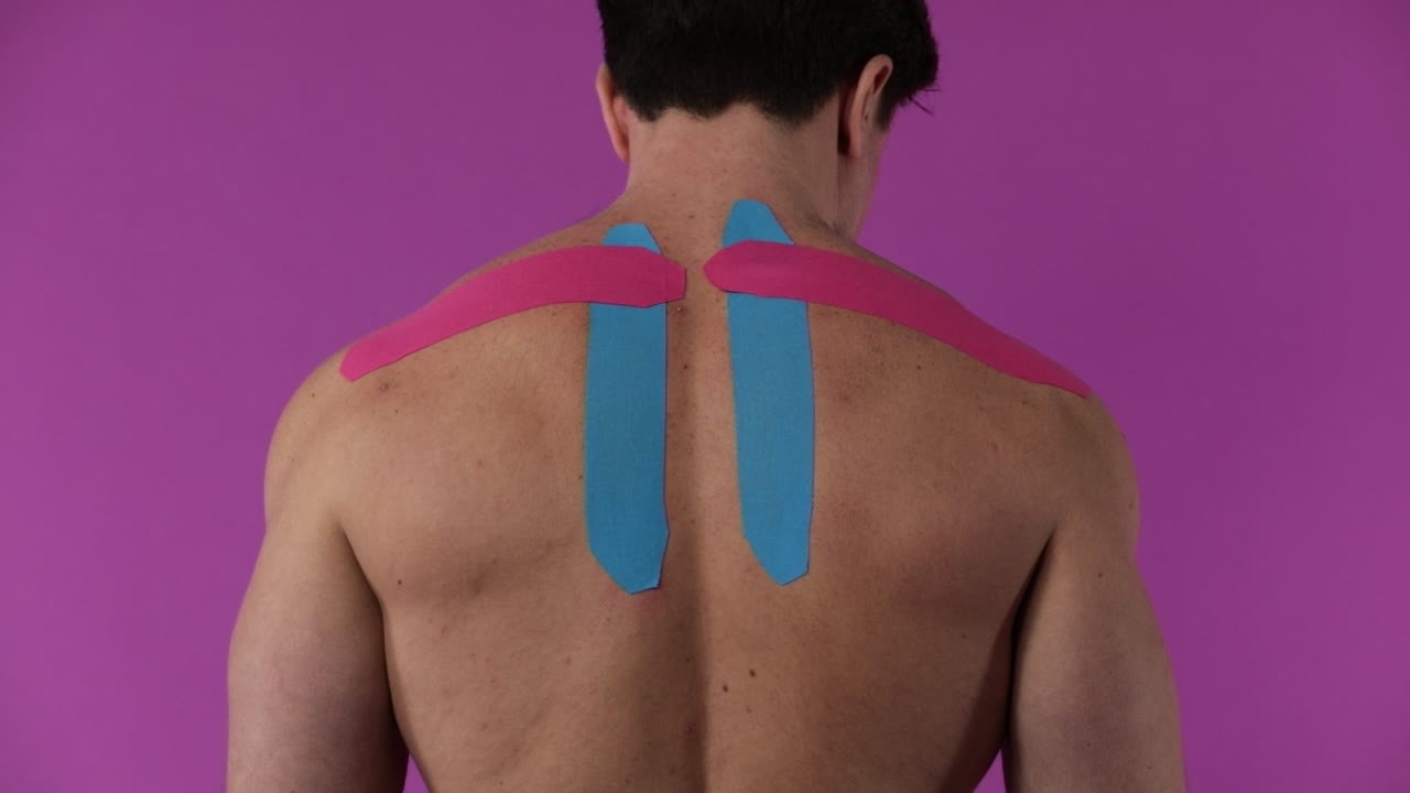 Applying Proworks kinesiology tape to the shoulder