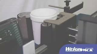 Wraparound labeler for conical containers