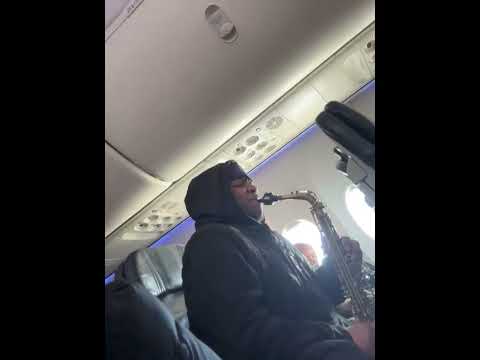 Casually playing sax on a plane in the middle of the flight.