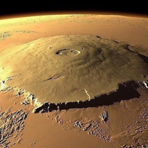 The tallest mountain in the solar system, Olympus Mons on Mars. It has ...