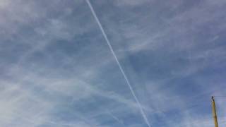 Contrail casting shadow on clouds