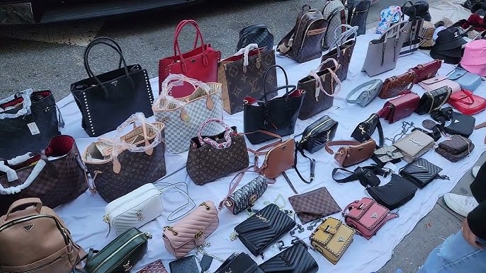 Street vendors on Canal Street selling imitation designer bags in all kinds  of weather. 