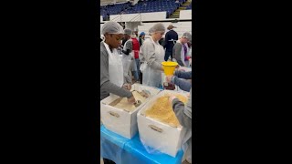 Volunteers with the United Way pack up food for those in need