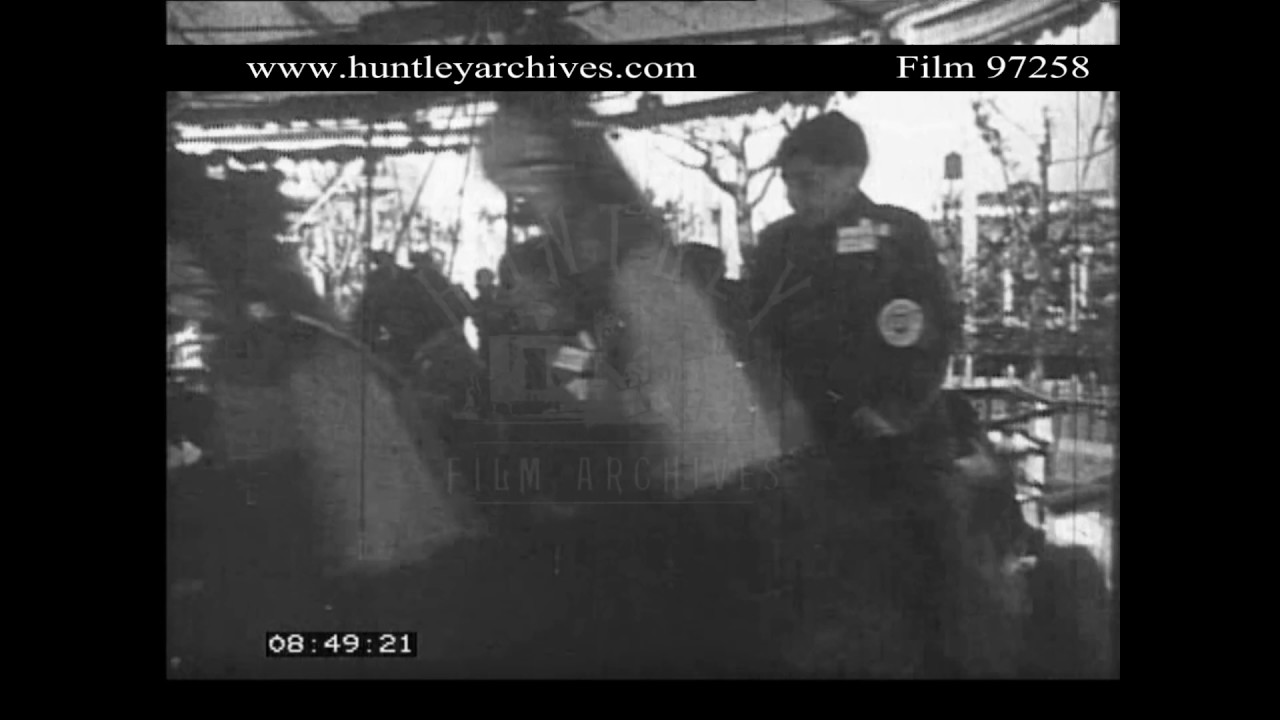 Happy children riding Gallopers at Fairground.  Archive film 97258