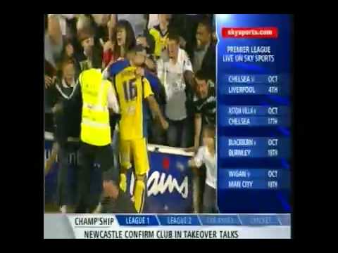 A young woman goes for a burton during some overenthusiastic celebrations by Leeds fans. This was just after Leeds' equalising goal which helped snatch victory for them at the Bescot Stadium against Walsall. Leeds scored two goals in the last ten minutes from Bradley Johnson and Jermaine Beckford.