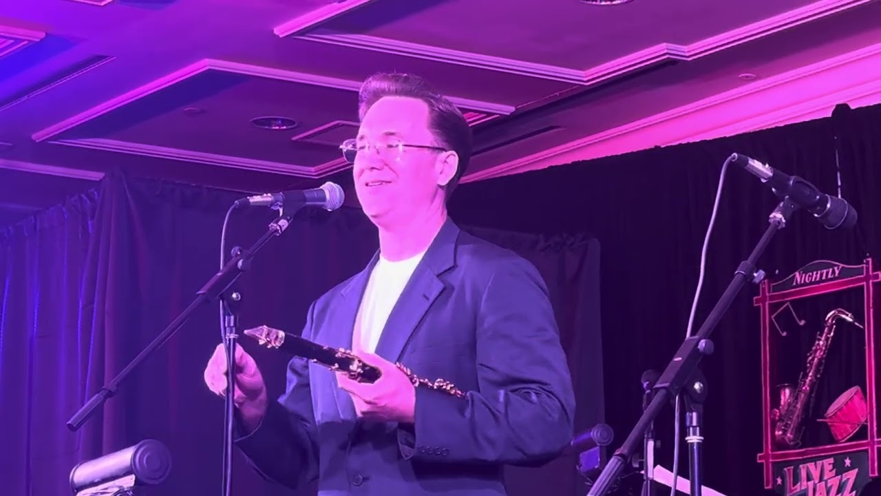 Clarinet player swinging jazz sextet performing live on stage