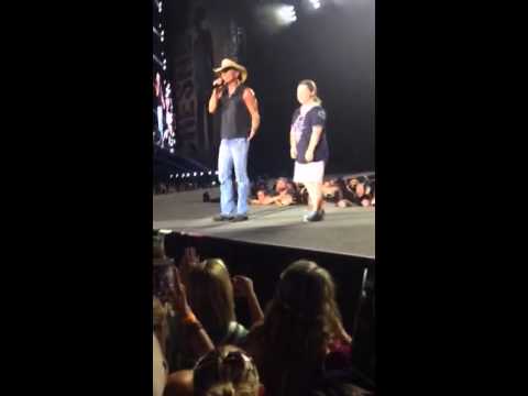 Girl up on stage with Kenny Chesney