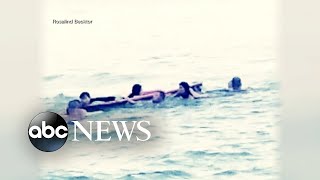 Beachgoers form human chain to rescue swimmers
