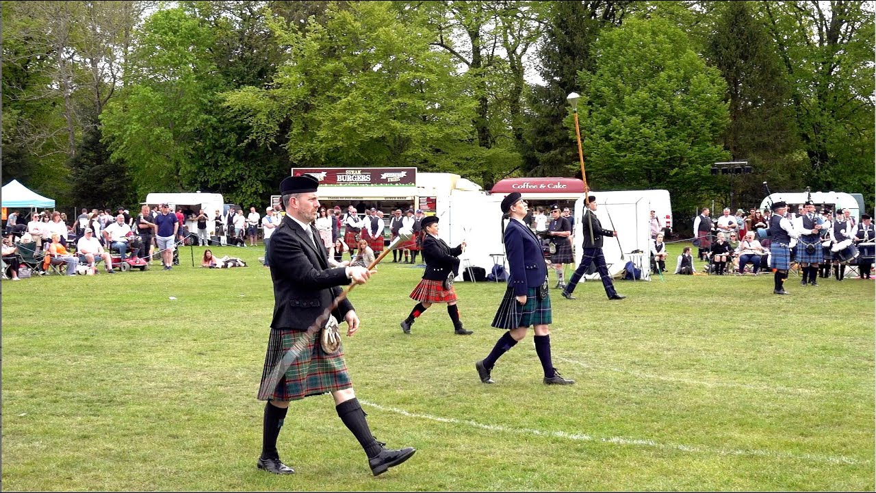 Drum Majors Mace flourish on the march during 2025 North Scotland Pipe Band Championship in Banchory