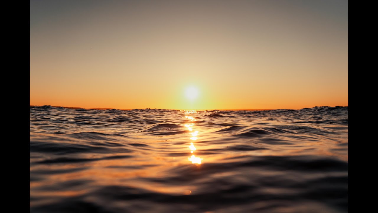 1 minute of slow motion ocean waves at sunset for relaxation