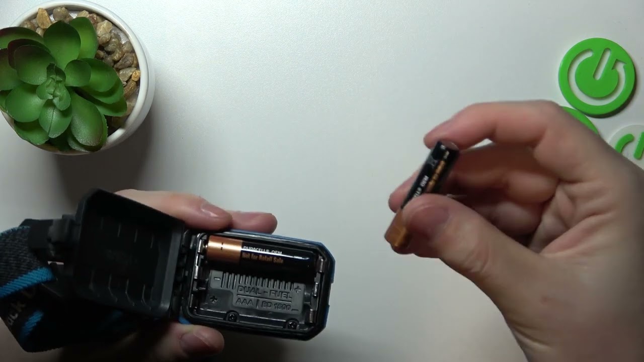 Black Diamond headlamp battery compartment diagram positive negative symbols