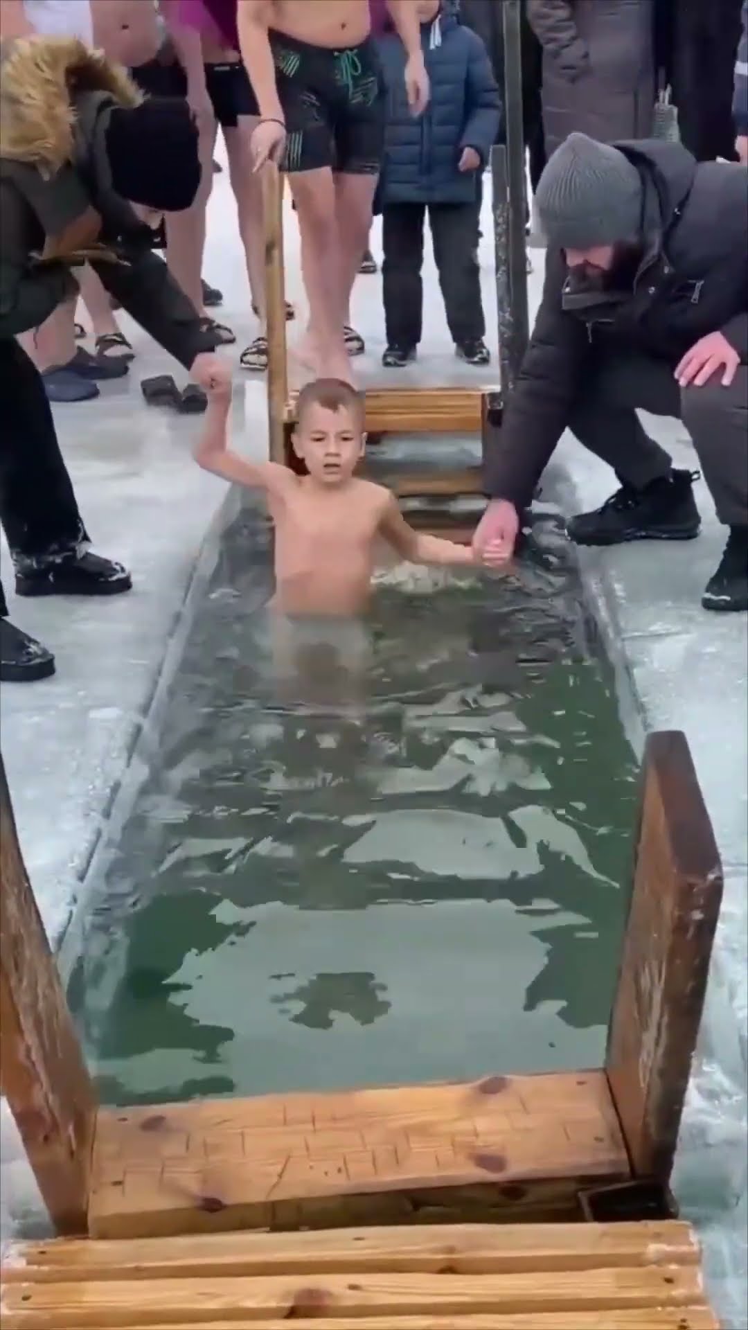 Man Slips into Icy Water While Holding Childs Hand During Epiphany