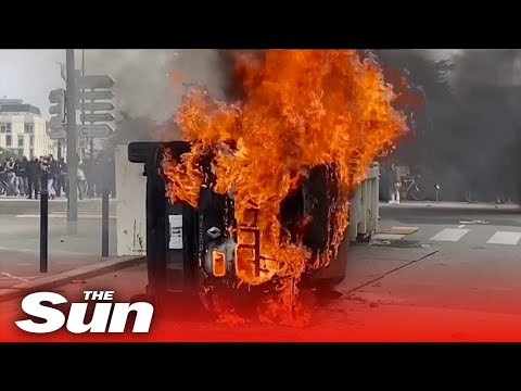 Protesters torch cars and clash with riot police over French pension reform.