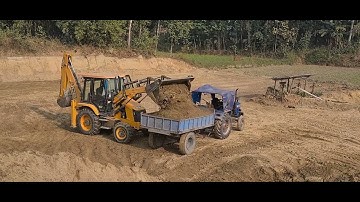 Jcb Backhoe machine cutting hill side soil and loading soil into the tractors